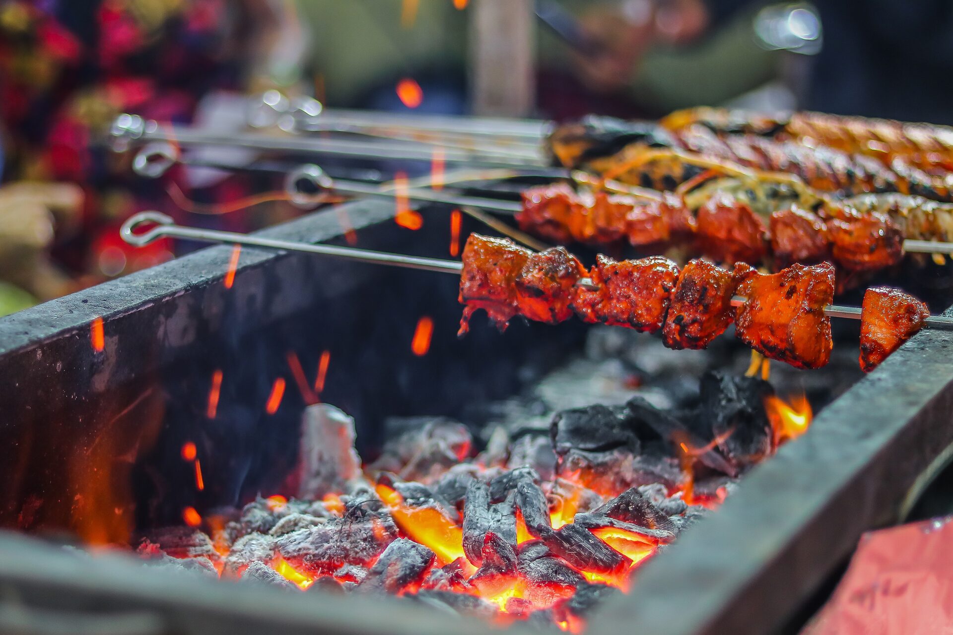 Skewers grilling over charcoal
